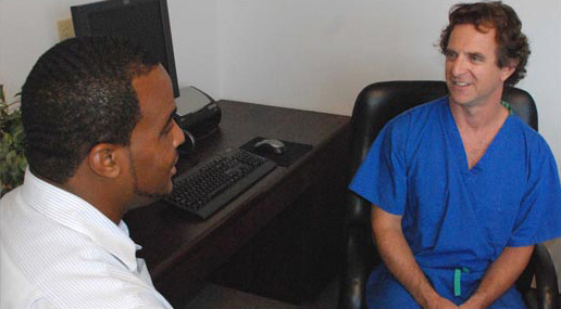 Dr. Yunis converses with a patient.